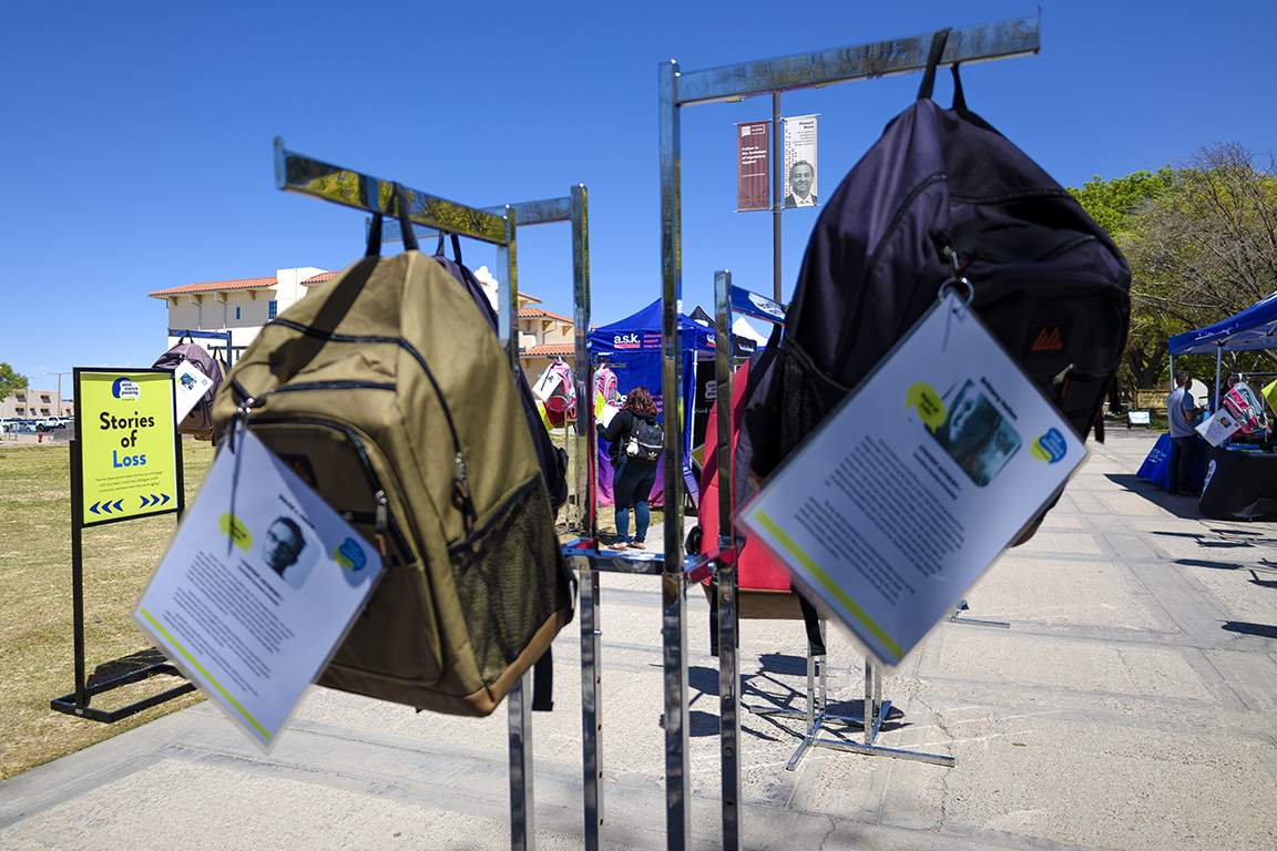 A patron reads through the many backpacks hanging at the Send Silence Packing event. April 7, 2025. 
