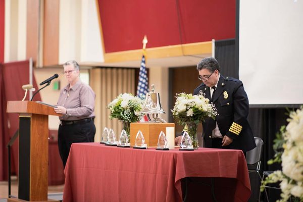 Flowers, a memorial bell, and plaques inscribed with the words “We remember them today, We remember them tomorrow. They are forever a part of our Aggie family. May 1, 2025