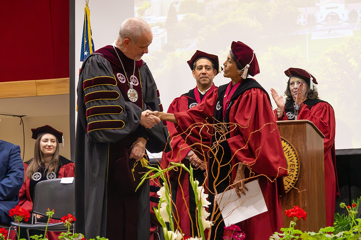Valerio Ferme shakes hands with Board of Regents chair Ammu Devasthali. April 24, 2025. 