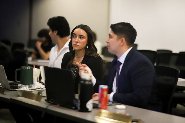 Two senators formulate questions during discussion of a bill at an NMSU Senate meeting. Apr. 24, 2025.