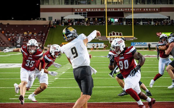 Linebacker Tyler Martinez (left) and Defensive Line Ezta Christensen (right) bolt towards a Bryant University Quarterback. Aug. 30, 2025. 