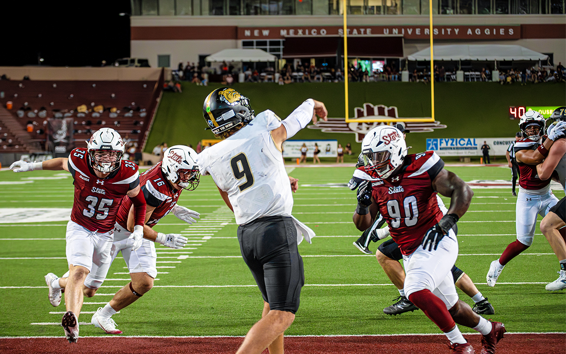 Linebacker Tyler Martinez (left) and Defensive Line Ezta Christensen (right) bolt towards a Bryant University Quarterback. Aug. 30, 2025. 