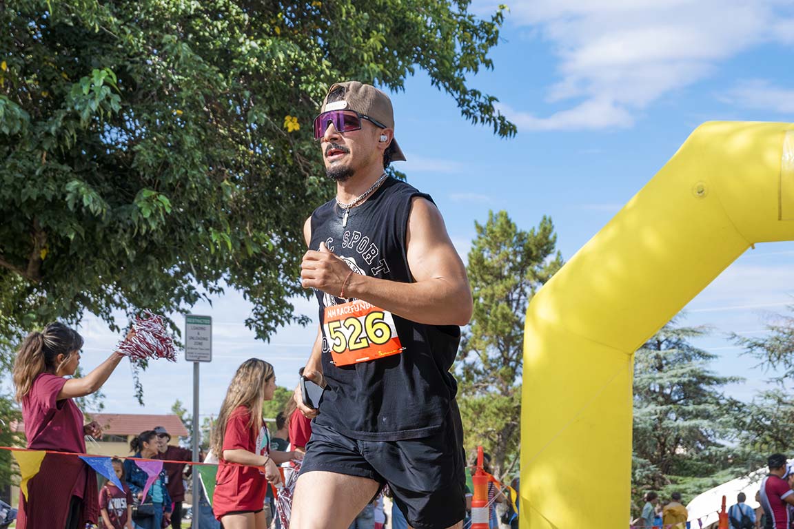 The crowd cheers as runners cross the finish line during the Gratitude Run on September 13, 2025.