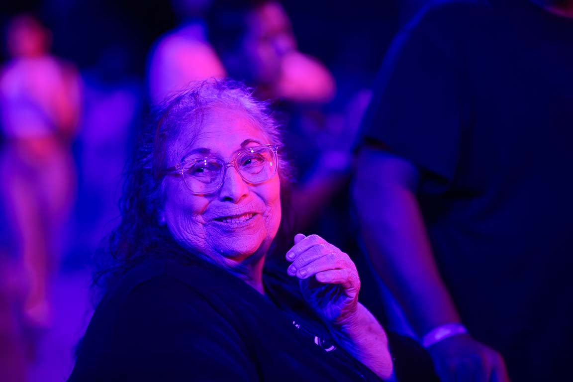 An attendee smiles as Frontera Bugalu performs at Cumbia Night II. Sept. 18, 2025. 