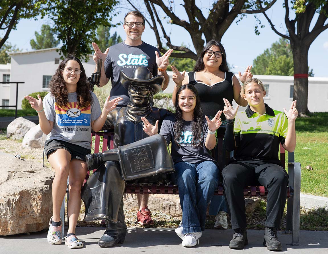 Women's rugby members Jessica Jimenez, Miranda Quintina, Alexus Jusko, Syra Jasso, Jessica Jimenez, and Justin Karrenberg (coach) show guns up with the Pete's statue outside of Corbett. September 10, 2025.