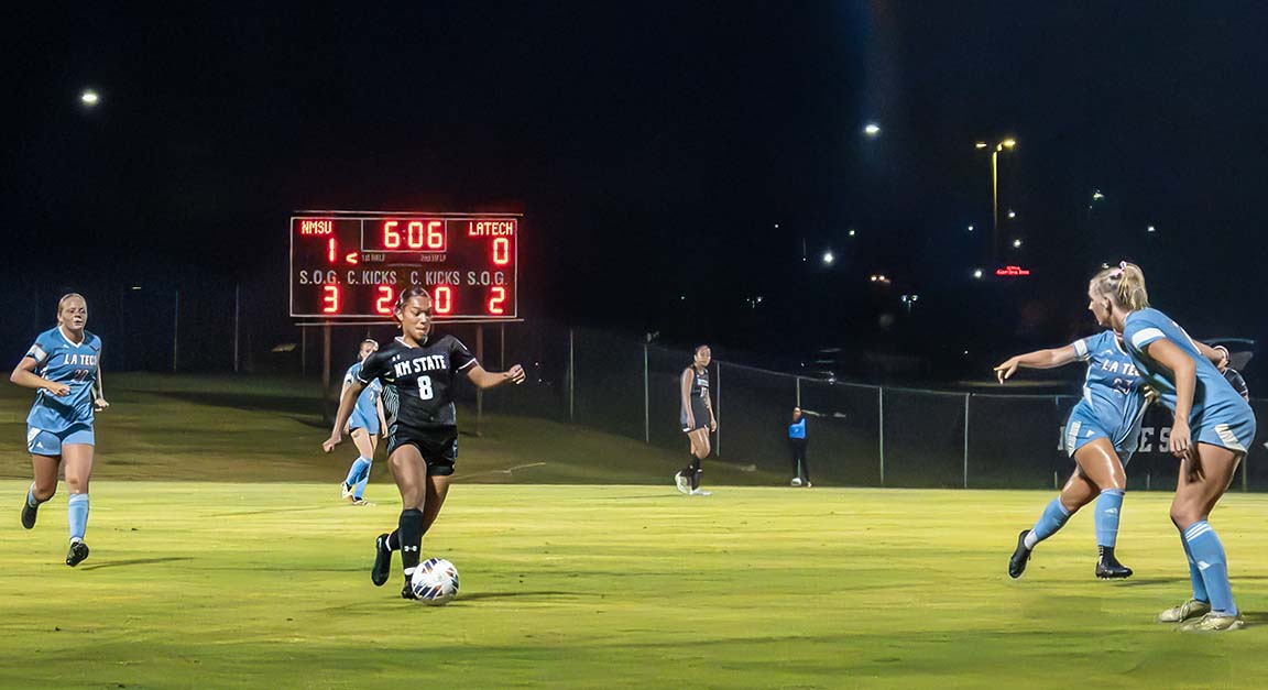 NMSU defender Marlee Cavitt moves the ball toward LA Tech’s side as Bulldog defenders prepare to block during the October 11, 2025, game. 