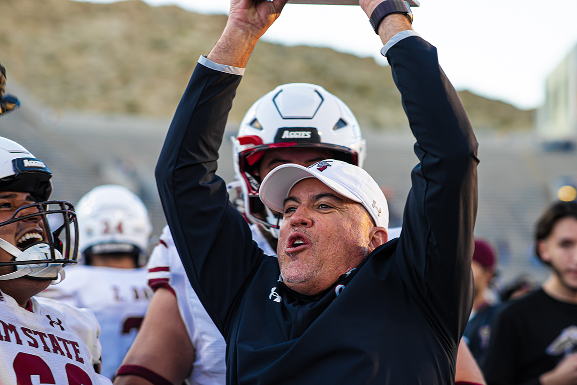 Head coach Tony Sanchez carries the Aggies’ victory trophy. Nov. 22, 2025. 
