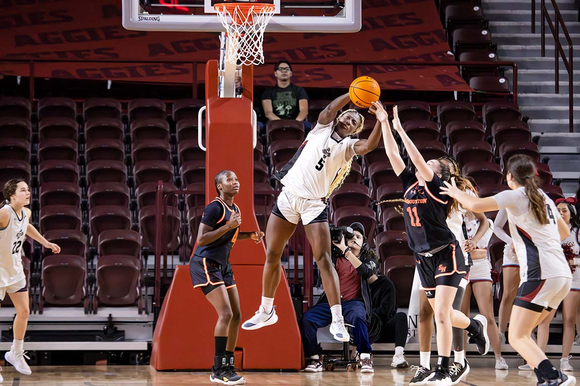 Midair, forward Morane Dossou grabs the ball to take possession for NMSU. Feb. 5, 2025.