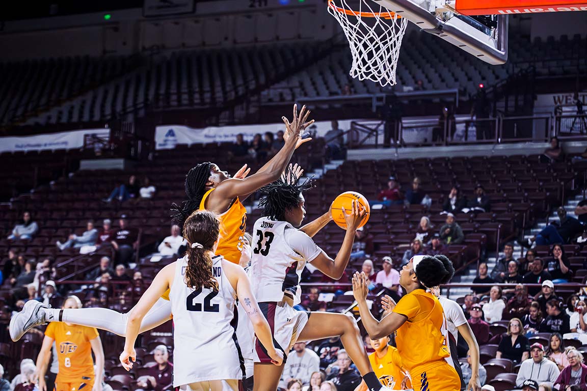 New Mexico State Aggies forward Senoj Jones (33) jumps toward the basket as a UTEP Miners defender challenges the shot during the I-10 matchup at the Pan American Center. Feb. 21, 2026. 