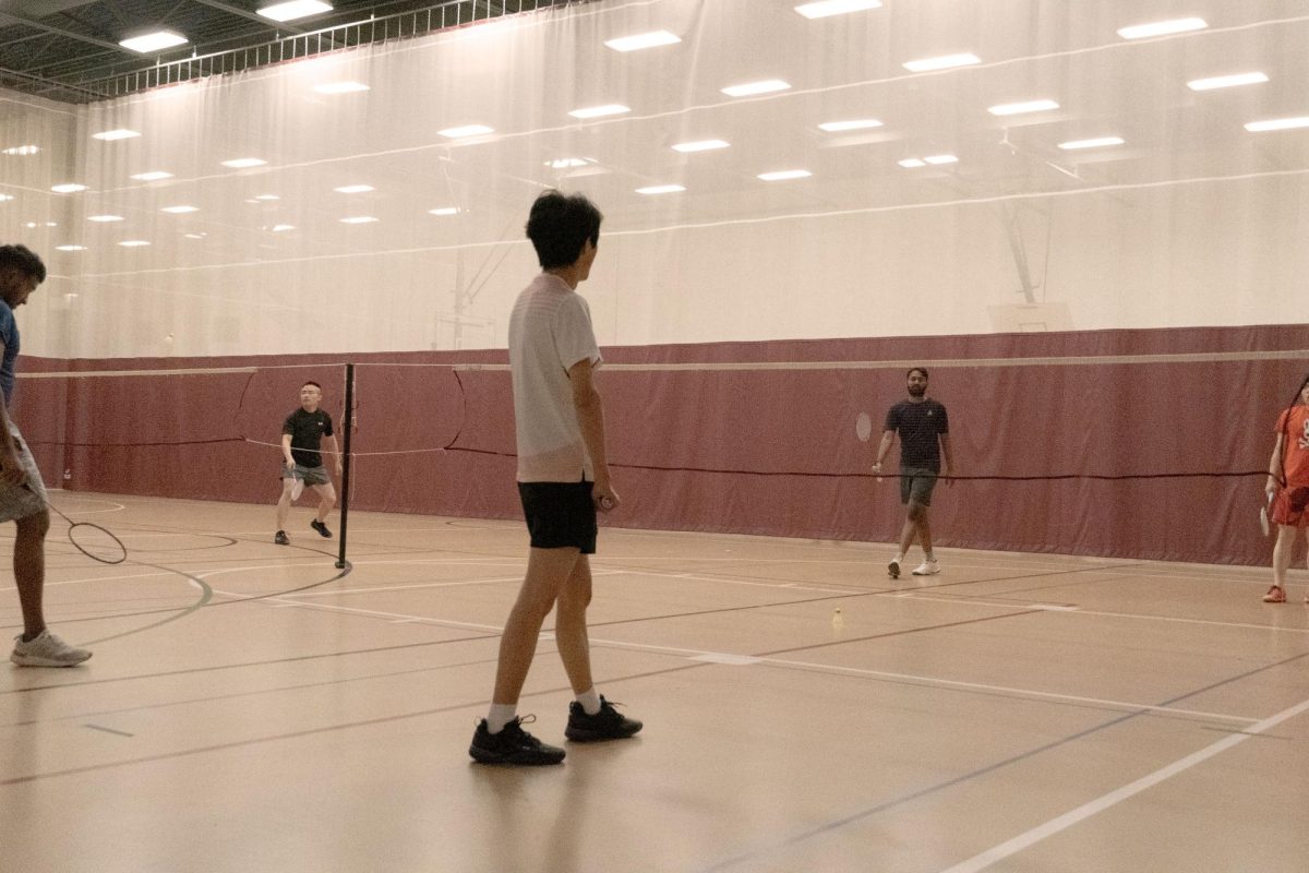 A member of the NMSU Badminton Club waits for his turn during a practice session. 