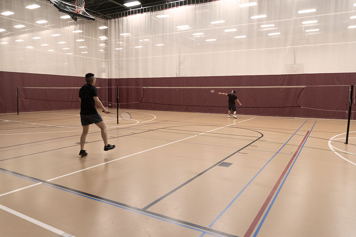 A member of the NMSU Badminton Club prepares to return a shot during a game. 