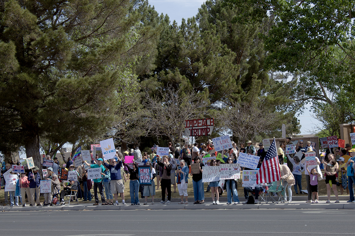 Hundreds of protesters stand at Albert Johnson Park holding many signs, some which read "Impeach Trump," "No King No ICE," and "take our country back from the billionaire, pedophile techno Epstein class!" March 28, 2026.