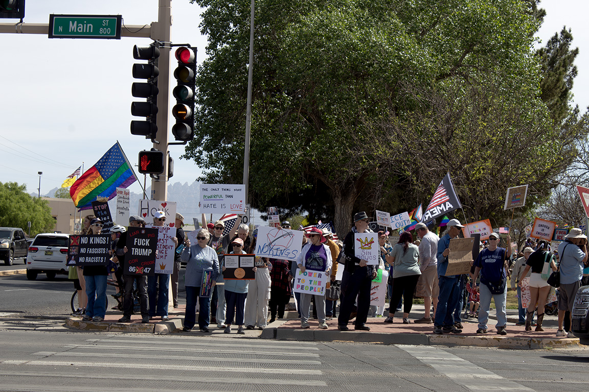 Dozens of protestors stand on N. Main Street with signs that read "The only thing more POWERFUL than hate is LOVE" and "No kings! No Fascists! No Racists!" March 28, 2026.