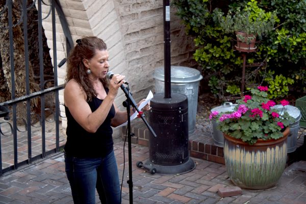 A poet shares her hand-written words with the crowd on April 2, 2026.