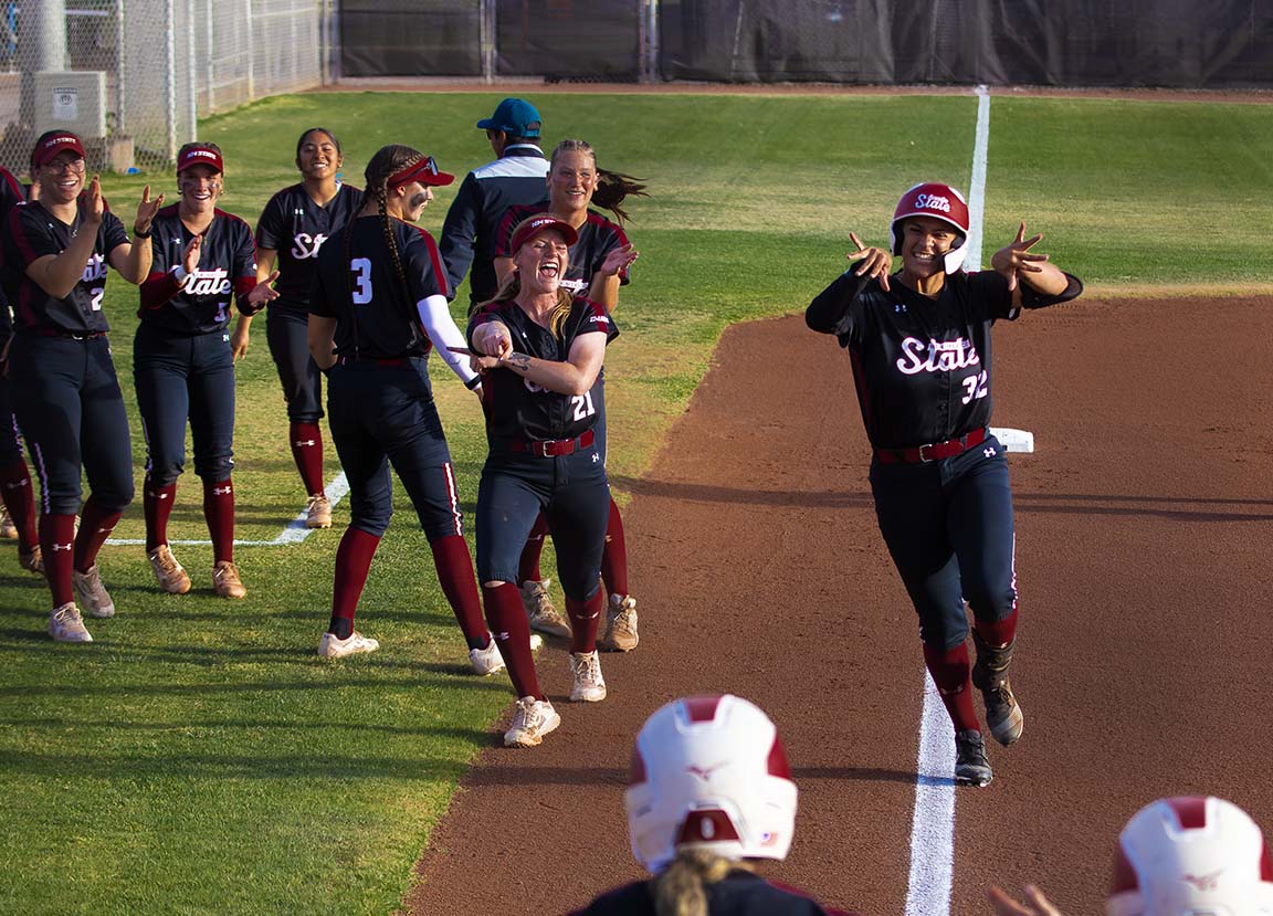 Teammates cheer from the field, March 27, 2026. 