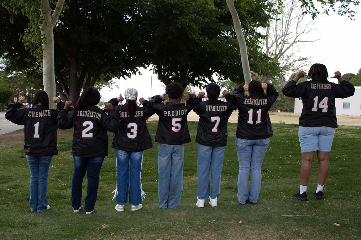 Seven AKA members pose proudly, showing off each of their numbers on their jackets. April 28,2026.  