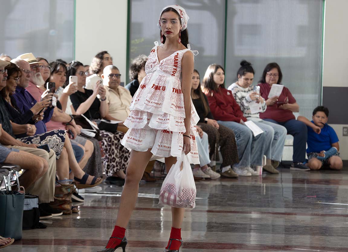 Model and designer Carolina Cardenas gives a dark stare while wearing a dress made from plastic bags. April 23, 2026. 