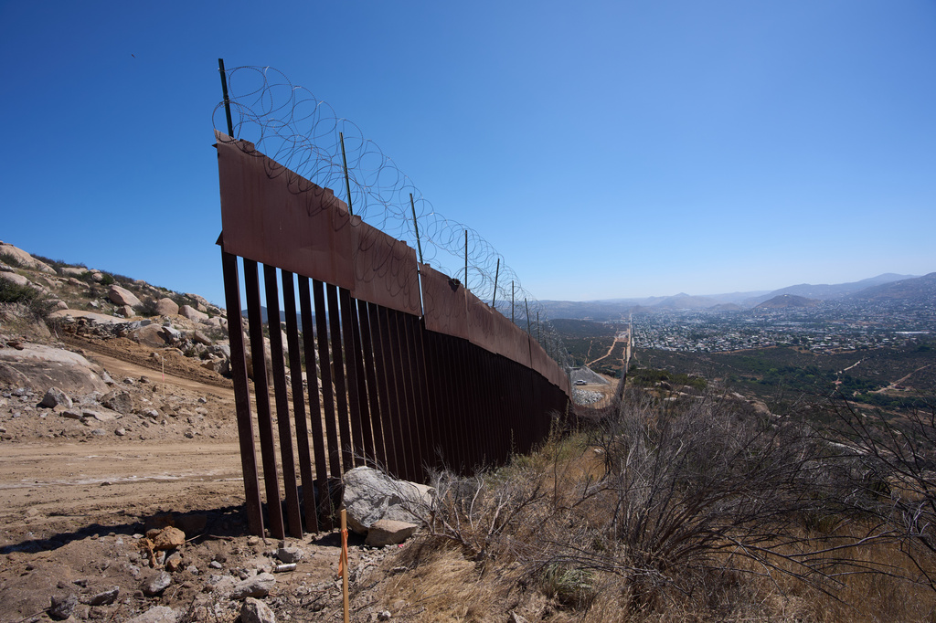 A section of border wall ends where new construction begins on Kuuchamaa Mountain Friday, April 24, 2026, seen from Tecate, Mexico. (AP Photo/Gregory Bull)
