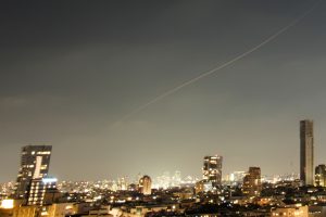 A projectile streaks through the sky over central Israel during an Iranian missile attack, Sunday, June 7, 2026. (AP Photo/Ohad Zwigenberg)